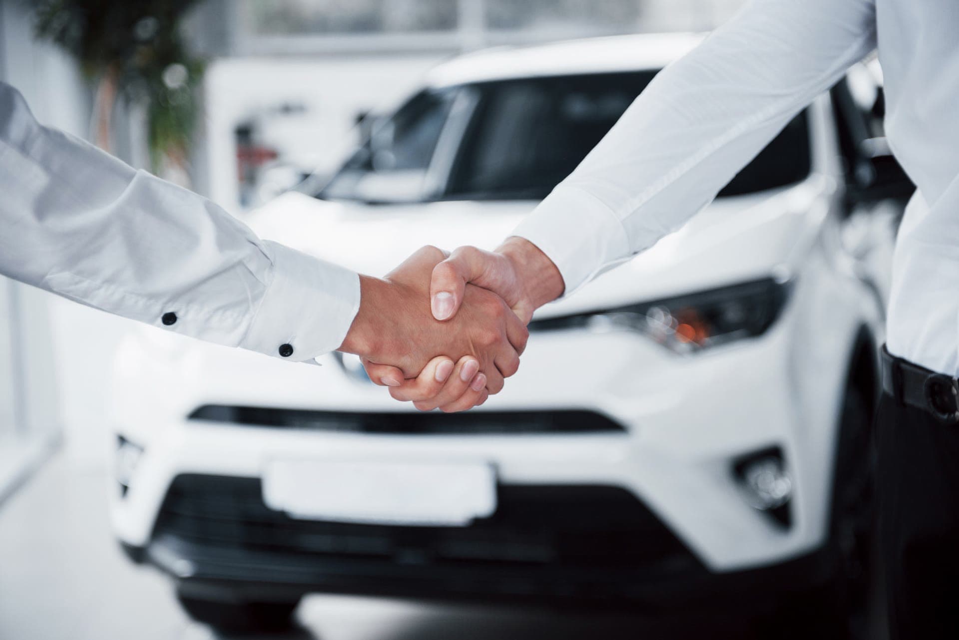 A satisfied customer holding their car keys after settling their loan